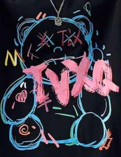 a black t - shirt with the word love written in pink, blue and green ink