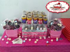 a table topped with lots of cupcakes and candy