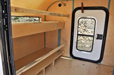 the inside of a small camper with bunk beds