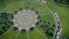 an aerial view of a circular building in the middle of a park