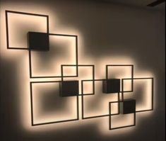 a wall that has some lights on it in the shape of squares and rectangles