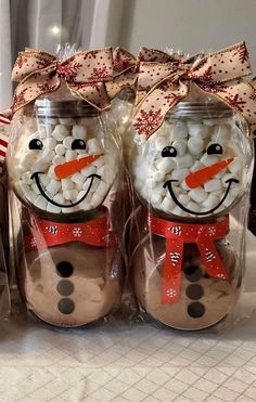 two jars filled with marshmallows in the shape of snowmen