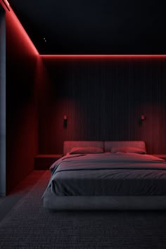 a large bed in a room with red lighting