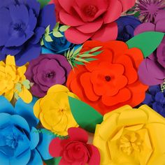 colorful paper flowers are arranged together on a table