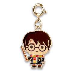 a keychain with a cartoon character holding a pen and pencil in its hand