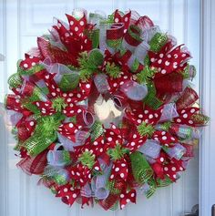 a red and green wreath with white polka dots