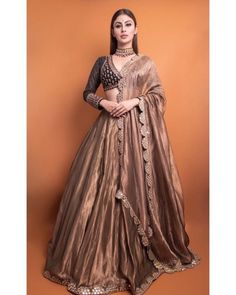 a woman in a brown lehenga