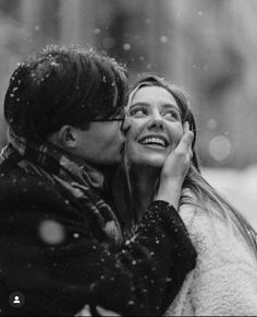 black and white photograph of two women kissing in the snow, one woman has her face close to the other