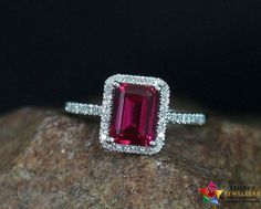 a pink tourmaline ring sitting on top of a rock