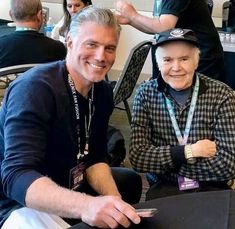 two people sitting next to each other at an event