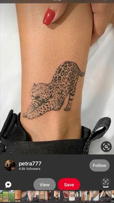 a woman's arm with a tattoo on it and an image of a leopard