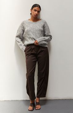 Built for the cool weather, this is a super soft and cozy sweater with classic cable-knit patterns. Crew neckline Long sleeves Drop shoulders Ribbed knit trim Large cable knit pattern Relaxed fit 82% Acrylic, 8% Nylon, 7% Wool, 3% Spandex Hand wash, Line dry Imported Brown Cable Knit Sweater For Loungewear, Relaxed Fit Cable Knit Sweater For Fall, Fall Cable Knit Sweater Relaxed Fit, Cozy Cable Knit Sweater In Relaxed Fit, Fall Cable Knit Sweater In Relaxed Fit, Brown Cable Knit Sweater For Work, Cable Knit Sweater For Winter Workwear, Cozy Cable Knit Sweater For Work, Cool Weather