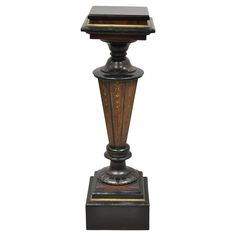 an old fashioned lamp with a wooden base