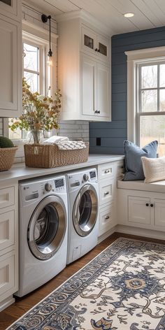 a washer and dryer sitting in a room next to a window with blue walls