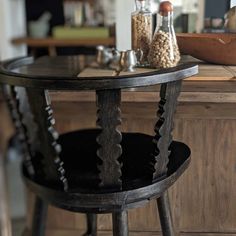 two wooden stools sitting in front of a table