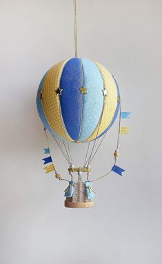 a blue and yellow hot air balloon hanging from a ceiling