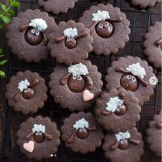 chocolate sheep decorated cookies on a cooling rack