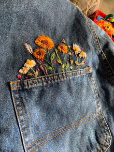 a jean jacket with flowers embroidered on it