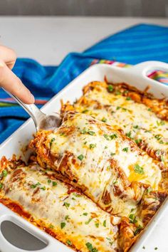 a white casserole dish filled with black bean enchiladas