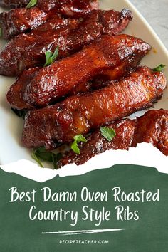 the best damn oven roasted country style ribs on a white platter with green trim