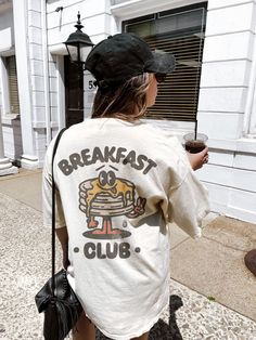 Breakfast Club Tee White Graphic Print T-shirt For Brunch, Trendy Relaxed Fit T-shirt For Loungewear, Comfortable Graphic Print T-shirt, Vintage Oversized T-shirt With Funny Print, Vsco Style Letter Print T-shirt For Streetwear, White Crew Neck T-shirt For Brunch, Casual Screen Print T-shirt For Brunch, Comfortable Graphic Print T-shirt For Streetwear, Comfortable Crew Neck T-shirt With Screen Print