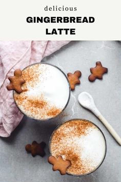 two mugs filled with gingerbread latte on top of a table next to cinnamon stars