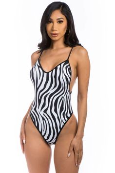 Make waves this summer in the "Zebra" One Piece Swimwear. Constructed with 20% nylon and 80% elastane, this memorable swimsuit offers V cut neck, plunge back, and medium bottom coverage for the perfect combination of comfort and style. Dare to stand out in the sun! EXCLUSIVELY SOLD at Amelia's Dream Showroom 245 E. Trinity Pl #1212 Decatur, GA 30030 Trendy Backless Bodysuit For Poolside, Trendy V-neck Bodysuit For Poolside, Trendy Stretch Bodysuit For Pool, Trendy Stretch Bodysuit For The Pool, Fitted Zebra Print Swimwear For Summer, Fitted Striped Seamless Swimwear, Striped Fitted Seamless Swimwear, Striped Seamless Fitted Swimwear, Trendy Stretch Bodysuit For Sunbathing