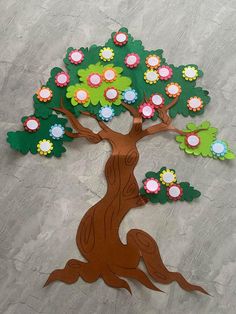 a paper cut out of a tree with flowers on it