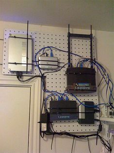 several electronic devices are connected to each other on a pegboard with wires and cords