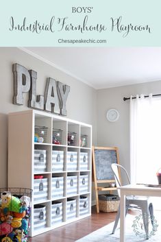 an organized playroom with toys and letters on the wall