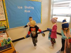 children playing on an ice skating rink in a classroom