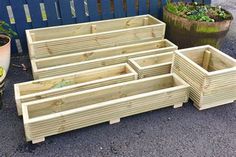 several wooden planters sitting next to each other