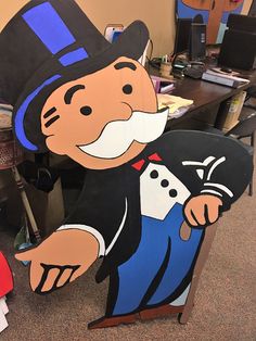 a cardboard cut out of a cartoon character holding a pirate's chest in an office