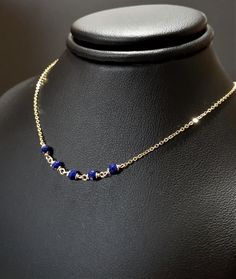 This dainty handmade necklace features 5 genuine Lapis Lazuli gemstones wrapped on a chain. This delicate choker necklace is beautiful worn alone or layered with other necklaces. A classic and simple everyday piece that will make fashion look effortless. Customize yours by choosing your metal and length. This necklace design is also available in different gemstones. Makes a great gift to add to any gemstone lover's collection. Perfect to gift for Christmas, Valentine's Day, Mother's Day, and mor Elegant Lapis Lazuli Necklace With Adjustable Chain, Blue Delicate Chain Necklace, Dainty Blue Wire Wrapped Necklace, Delicate Choker Necklace, Delicate Choker, Make Fashion, Lapis Lazuli Necklace, Necklace Design, Faceted Gemstones