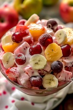 a fruit salad in a glass bowl on a table