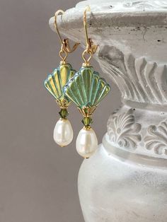 I created these Art Deco inspired earrings with some of my favorite jewelry components - Czech glass beads, Swarovski crystals, and Swarovski pearls. This is a classic Deco design; perfect for a 1920s style wedding or party. The Czech beads are shaped like fans; one of the most popular design motifs during the Art Deco period. Each Czech glass bead has a Aurora Borealis finish on one side and a solid peridot green color on the opposite side. (SEE PHOTO 2) Beautiful Swarovski crystals and pearls 1920s Style Wedding, Flapper Jewelry, Art Deco Jewelry 1920s, 1920s Earrings, Teardrop Pearl Earrings, Green Art Deco, Art Deco Fan, Design Motifs, Pearl Jewels