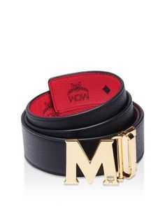 Available in a variety of colorful options to complete any look, this sleek leather belt from Mcm features a polished M-buckle and a reversible design with a logo-stamped interior. Luxury Black Belt With Logo Strap, Luxury Black Belts With Logo Strap, Luxury Business Belt With Logo Plaque, Luxury Business Belts With Logo Plaque, Designer Black Belt With Logo Strap, Black Leather Belt With Logo Strap, Luxury Leather Belt With Logo Strap, Designer Leather Belt With Logo Strap, Luxury Belt Buckles With Metal Logo