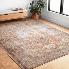 a large area rug in an empty room with wooden flooring and window sill