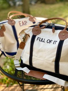 "This Weekender bag is perfect for a quick overnight trip or weekend getaway. The classic style boat tote in a variety of strap accent colors can be monogrammed or embroidered with your choice of phrases. Up to 10 characters per line, up to 3 lines of space. Choose a name, team, or my personal favorite- go with a funny phrase. So many font choices and monograms available, reach out if you don't see quite what you're after or need inspiration! 15\" H X 28\" W X 10\" D 3.45 lbs 18 oz Canvas Top zip closure with leather accent pullers Genuine leather handles Internal pocket with zipper closure Brass clips for removable shoulder strap Weekenders have a zipper closure & exterior pocket, as well as interior pockets that zip. They are sturdy and durable canvas that is made to last. with genuine l Overnight Bag For Boyfriends House, Summer Day Outfits, Canvas Duffel Bag, Boat Bag, Boat Tote, Personalized Makeup Bags, Sac Week End, Weekend Bag, 90s Style