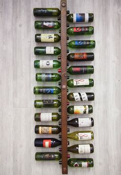 a wine rack with many different types of bottles hanging on it's side,