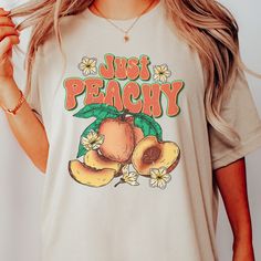 summer time graphic shirt | peachy tee | botanical shirt | fruit drawing tshirt | fresh peaches shirt |  This Bella T-shirt is light-weight with just the right amount of stretch. Perfect for wearing on its own or layering with a jacket or cardigan - this Tee is comfortable, soft, and durable. * 100% combed and ring-spun cotton * Fabric weight: 4.2 oz (142 g/m2) * Pre-shrunk fabric * Side-seamed construction * Shoulder-to-shoulder taping * We do not accept returns or exchanges. However, if you experience an issue with them item received, please message the shop Woah there! It looks like you've gone a little too far - don't like this tshirt? No problem, we won't take it personally 😉 You can check out some of our other great designs back at our shop here: https://www.etsy.com/shop/TheSimplyS Fruit Tshirt Design, Trendy Peach T-shirt With Letter Print, Casual Peach T-shirt With Graphic Print, Casual Peach T-shirt With Letter Print, Spring Peach Crew Neck T-shirt, Trendy Peach Top With Graphic Print, Relaxed Fit T-shirt With Fruit Print For Spring, Trendy Peach Relaxed Fit T-shirt, Trendy Relaxed Fit Peach T-shirt