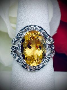 Natural Yellow Citrine Ring and Curved Band Set Option Edward Design#70 Made To Order This filigree ring is an Edwardian antique reproduction in sterling silver set with a 4+ carat natural honey-yellow citrine gemstone solitaire. This faceted cut oval gem is 14mm x 10mm. This ring sits 7mm off the finger. The inside of the band is marked 925 for sterling silver. This ring now has a matching floral accompanying curved band. This band was specially designed to fit this ring perfect. You can elect Yellow Gemstones For Wedding, Fine Jewelry, Fine Jewelry Yellow Gemstones For Wedding, Yellow Gemstones For Wedding Fine Jewelry, Amber Oval Topaz Ring For Wedding, Fine Yellow Gemstones For Wedding, Elegant Citrine Rings With Diamond Cut, Formal Citrine Ring With Diamond Cut, Formal Citrine Diamond-cut Ring, Formal Citrine Diamond Cut Ring