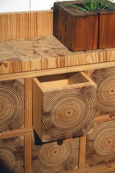 a wooden dresser with drawers and planter in the top drawer, made out of wood