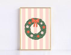 a christmas wreath on a pink and white striped background with red polka dots in the middle