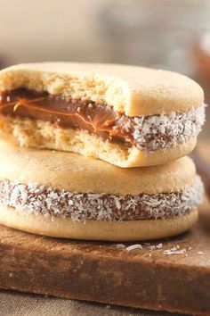 two cookies are stacked on top of each other with chocolate frosting and powdered sugar