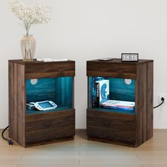 there are two wooden cubes with electronic devices in them on the floor next to each other