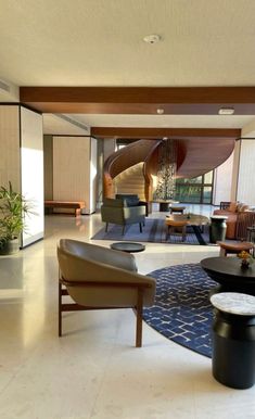 a living room filled with furniture and a spiral staircase