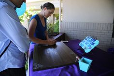 two people standing at a table with a sign on it that says do not enter