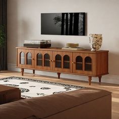 a living room scene with focus on the entertainment center and large window to the outside