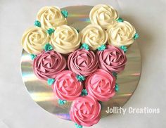 a cake decorated with pink and white frosting roses